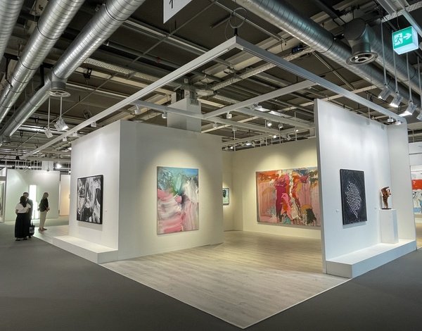 painting exhibition stand at Art Basel inside big event hall with grey latex-free carpet